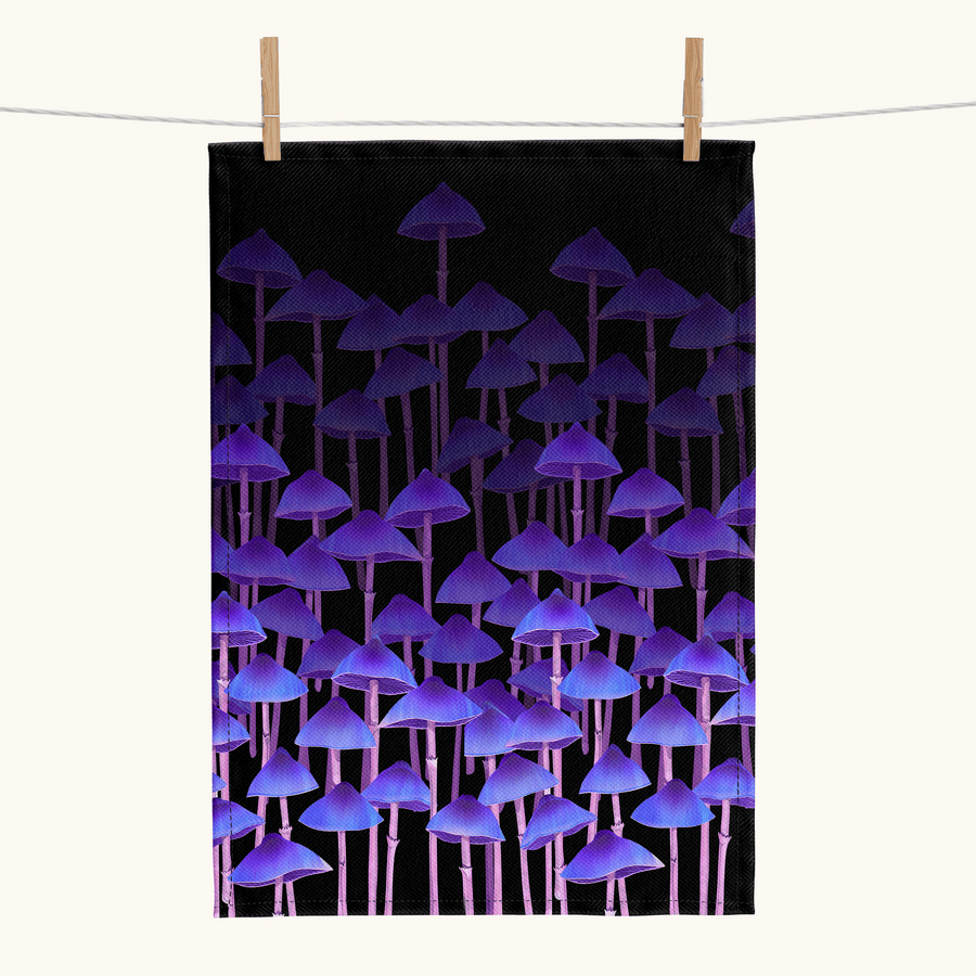 linen tea towel printed with rows of tall purple mushrooms against a black background 