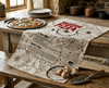 linen tea towel  with a mushroom pattern and a mushroom pizza recipe on a kitchen bench with a mushroom pizza
