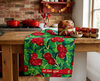 linen tea towel featuring a red bush apple pattern on a bench in a kitchen with food items
